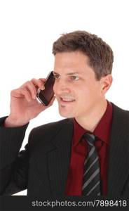 A smiling young businessman talking his cell phone, isolatedfor white background.