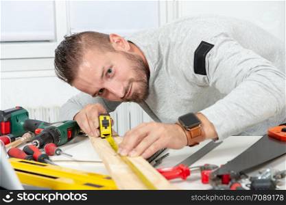 a smiling young man DIY at home