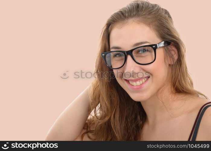 a smiling young woman with black glasses, on light pink background