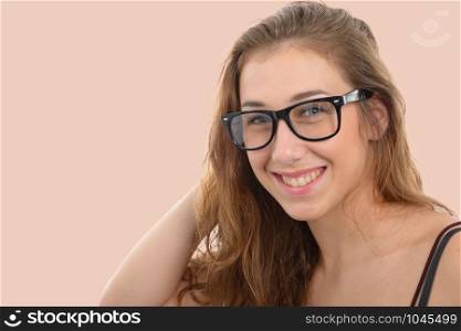 a smiling young woman with black glasses, on light pink background
