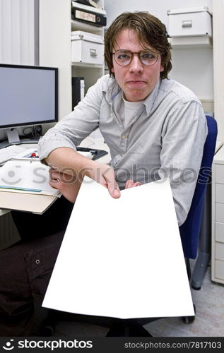 A smug looking young man, showing or handing over a piece of paper with a finalized solution in an office environment