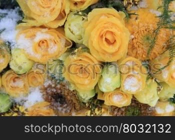 A snow covered mixed yellow bouquet