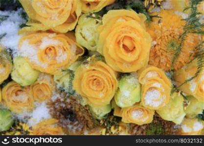 A snow covered mixed yellow bouquet
