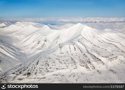 A snow covered mountain range in Svalbard