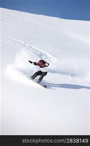 A snowboarder floating down a mountain