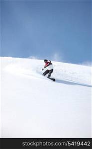 A snowboarder gliding down a slope