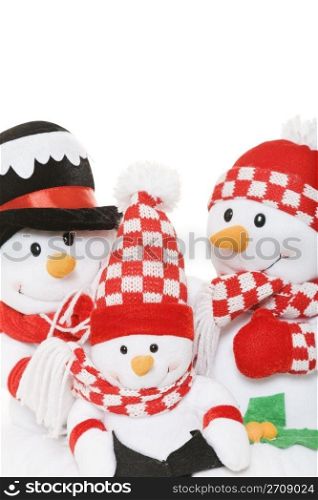 A snowman family dressed in winter attire.