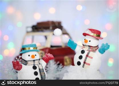 A snowman playing snow and decorations on bokeh background with copy space for season greeting Merry Christmas or Happy New Year, AF point selection.
