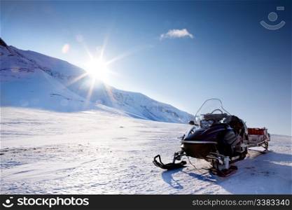 A snowmobile in a winter mountain landscape
