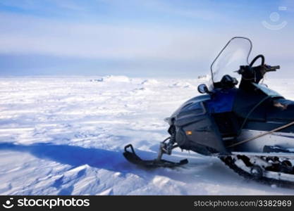 A snowmobile on a barren winter landscape