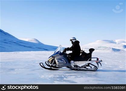 A snowmobile on a beautiful winter mountain landscape