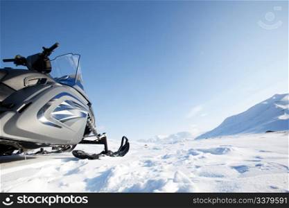 A snowmobile on a winter wilderness landscape