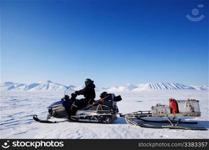 A snowmobile on an arctic expedition on a frozen lake