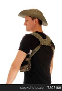 A soldier in a black t-shirt and pistol holster, wearing a hat, standingfrom the back, isolated for white background.
