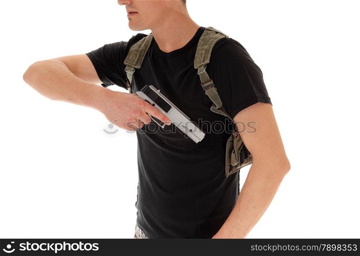 A soldier in black t-shirt, pulling his hand gunout of the holster, isolated on white background.