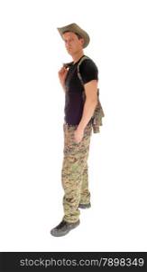 A soldier in camouflage pants and black t-shirt and hat standing relaxed,isolated for white background.