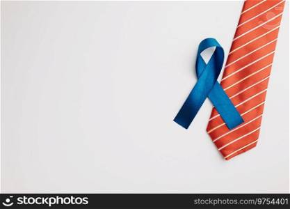 A solitary blue ribbon, representing prostate cancer and men’s health awareness, demands attention on a white backdrop in November and September.