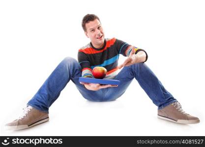 A sound mind in a healthy body - concept of mental nutrition - man with book and apple white background