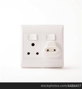 A South African Electric Double Wall Plug with an adapter for a two point plug situated on a white background.