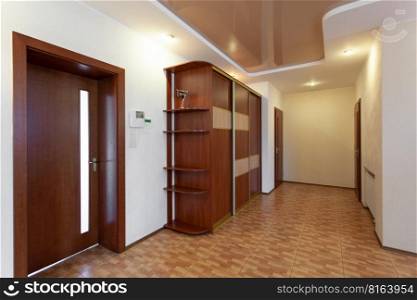 a spacious corridor in the house with doors to the rooms