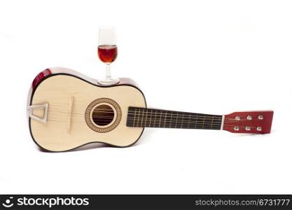 a Spanish guitar, and a glass of wine, two typical symbols of Spain