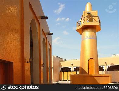 A spectacular mosque, clad in gold-coloured mosaic tiles, in Katara cultural village, West Bay, Doha, Qatar.