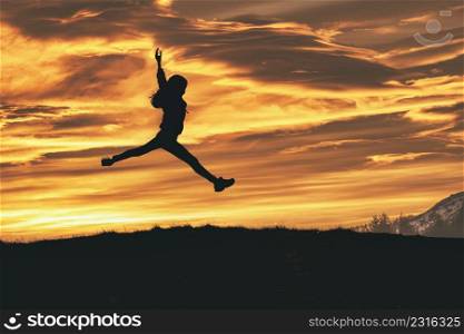 A split in the sky during a run in nature. A young girl in silhouette