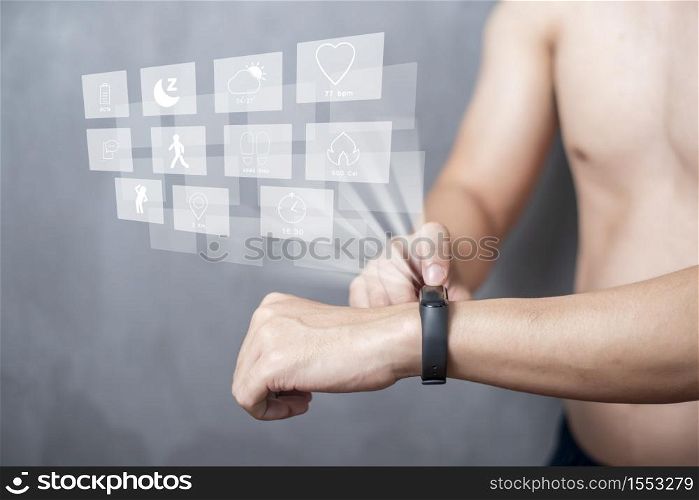 A Sport man is using smart band with virtual screen device