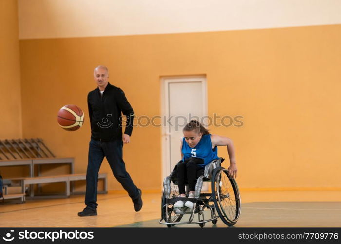 a sports basketball coach explains to a disabled woman in a wheelchair which position to play during a game. High quality photo. a sports basketball coach explains to a disabled woman in a wheelchair which position to play during a game