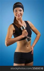 a sports girl posing with dumbbell