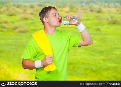 a sportsman drinking water from bottle