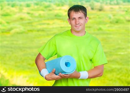 a sportsman holding yoga mat