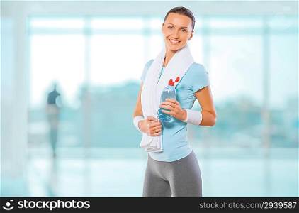 a sportswoman holding bottle of water