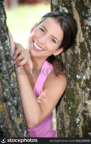 a sporty woman between two trees