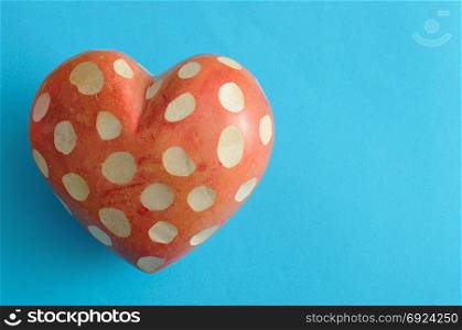 A spotted heart isolated on a blue background