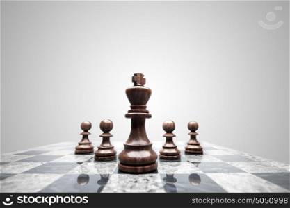 A squad of 5 chess pieces leaded by the king.