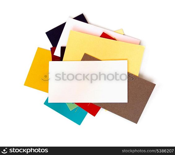 A stack of assorted business cards with blank white card on top