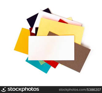 A stack of assorted business cards with blank white card on top