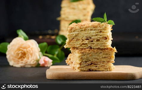 A stack of baked Napoleon pie slices with cream. Puff pastry, delicious dessert