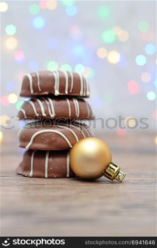 A stack of chocolate covered biscuits and a golden babble