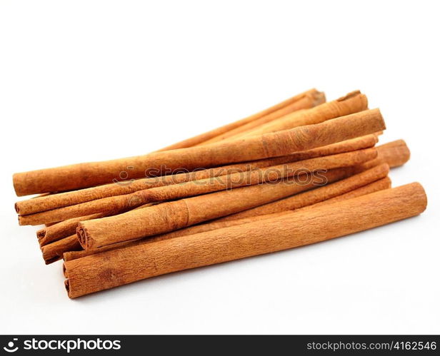 a stack of cinnamon sticks on white background