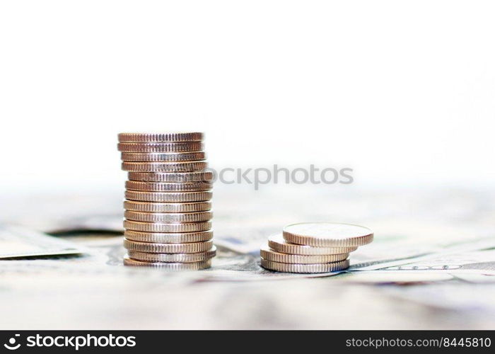A stack of coins on an isolated white background. dollars background.. A stack of coins on an isolated white background. dollars background