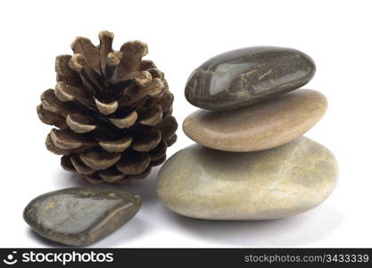 A stack of colored pebbles with a pine cone