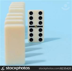 A stack of dominoes on a blue background, an intellectual game