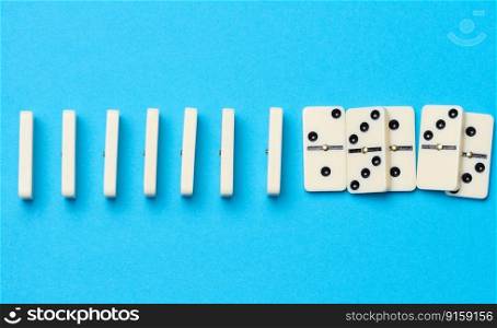 A stack of dominoes on a blue background, an intellectual game. Top view