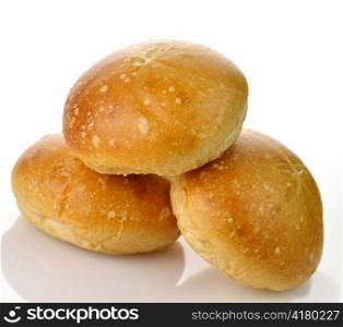 a stack of fresh breakfast rolls on a white background