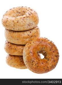 A stack of golden brown, multi-grain bagels. Shot on white background.