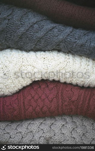 a stack of knitted sweaters. warmth and comfort. Hobby