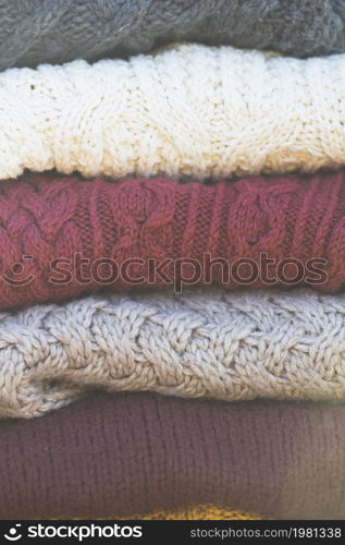 a stack of knitted sweaters. warmth and comfort. Hobby