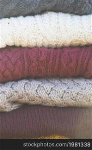 a stack of knitted sweaters. warmth and comfort. Hobby
